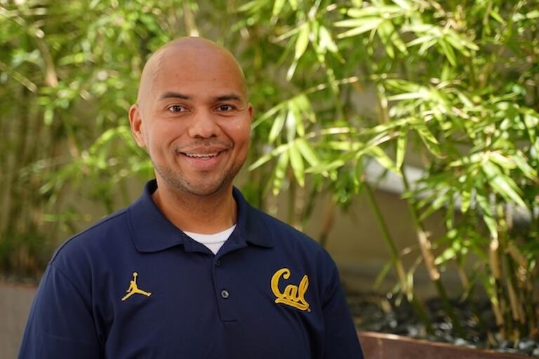 Professional headshot of a male, in a blue shirt